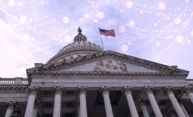 front of government building with American flag and with tech background